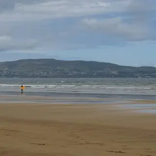 The long beach at Benone with the hills of Inishowen across the water