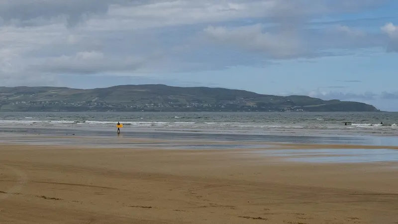 The long beach at Benone with the hills of Inishowen across the water