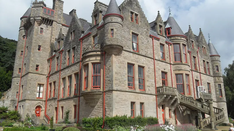 The sandstone towers and turrets of Belfast Castle above its formal garden