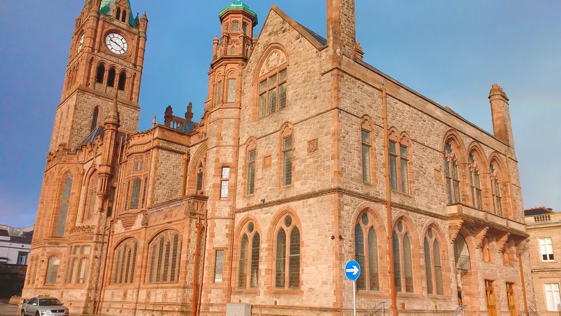 The red sandstone Guildhall in Derry with its clock tower, on a wet evening