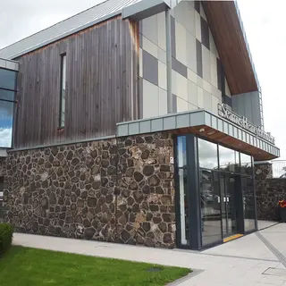The timber and dark stone front of Seamus Heaney HomePlace in Bellaghy