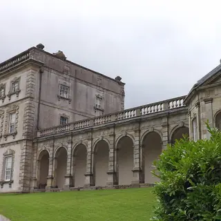 The grey stone front of Florence Court with its arcaded wing running off to the side