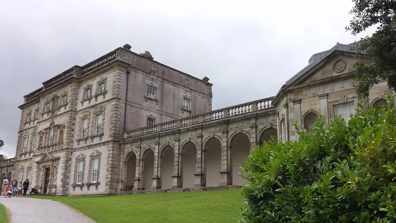 The grey stone front of Florence Court with its arcaded wing running off to the side