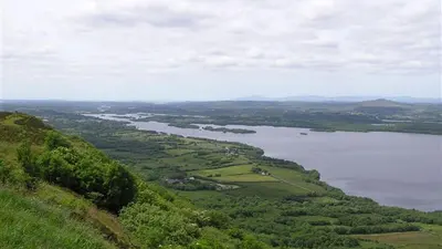 The view from the top of the Magho cliffs down over wooded slopes to Lower Lough Erne