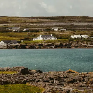 Traditional houses above the rocky shoreline on Inis Mór