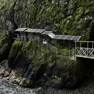 A walkway and tubular bridge fixed to the sea cliffs on the Gobbins path