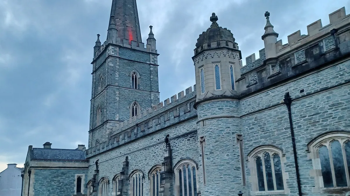 St Columb's Cathedral in Derry with its tall spire, seen from the churchyard