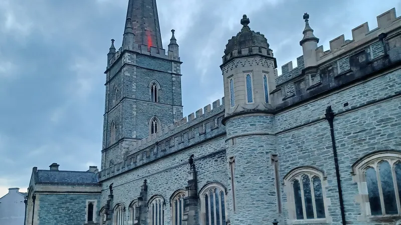 St Columb's Cathedral in Derry with its tall spire, seen from the churchyard