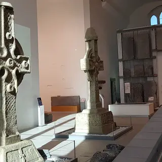 Carved stone crosses on display inside the Medieval Mile Museum