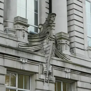 A carved stone figure set into the classical front of the Ulster Museum