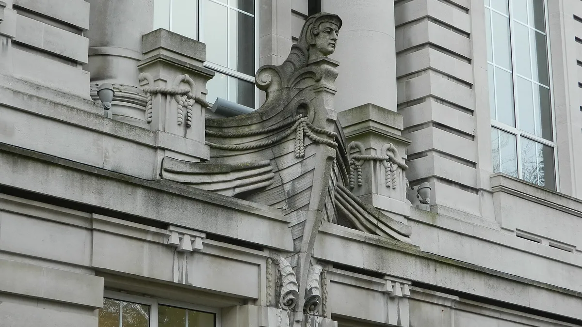 A carved stone figure set into the classical front of the Ulster Museum