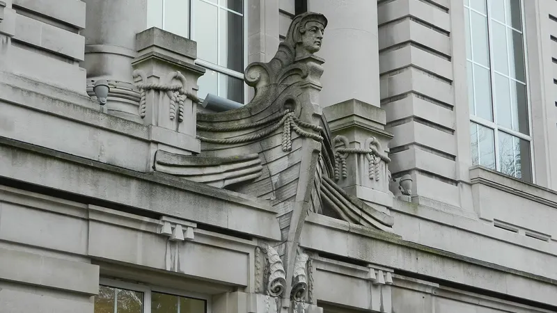 A carved stone figure set into the classical front of the Ulster Museum