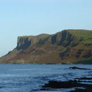 The high flat topped cliff of Fair Head rising out of the sea