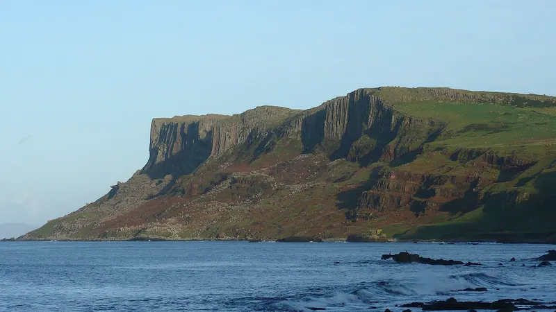 The high flat topped cliff of Fair Head rising out of the sea