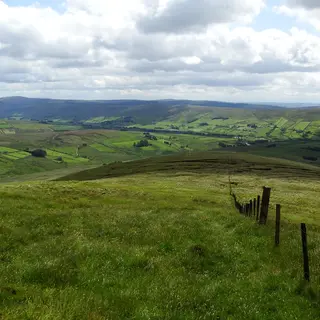 Looking down a green ridge into the Glenelly Valley, with the Sperrin hills rolling away beyond it