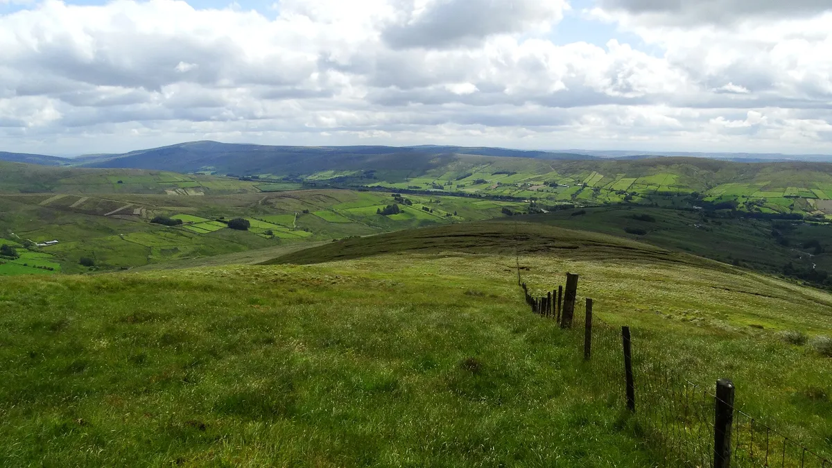 Looking down a green ridge into the Glenelly Valley, with the Sperrin hills rolling away beyond it