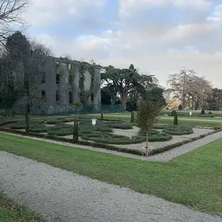 The ruined shell of Woodstock House above its formal garden