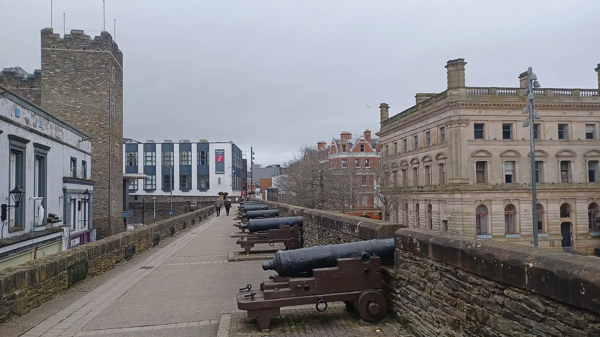 A row of old cannon along the broad walkway on top of the Derry city walls