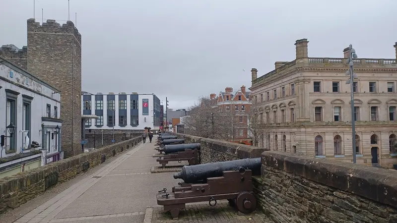 A row of old cannon along the broad walkway on top of the Derry city walls