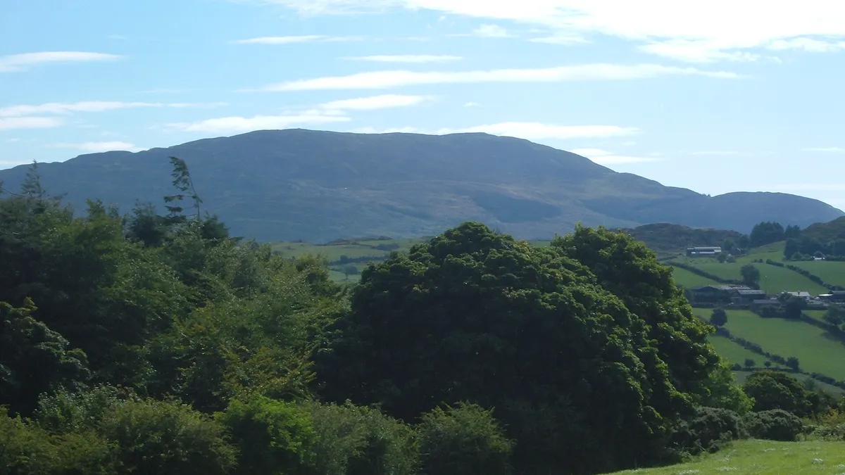 Slieve Gullion rising above green fields and woodland
